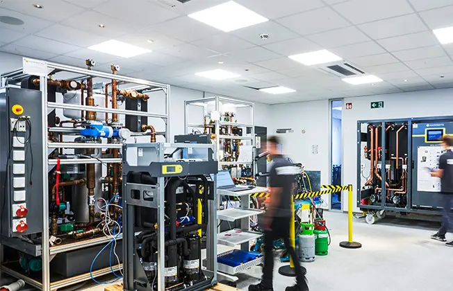 Two Waterkotte developers working at test benches in the Waterkotte development center.