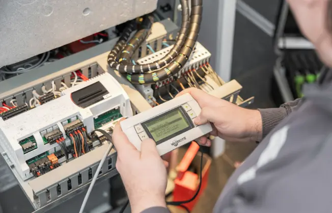 WATERKOTTE service employee performing maintenance on a heat pump.