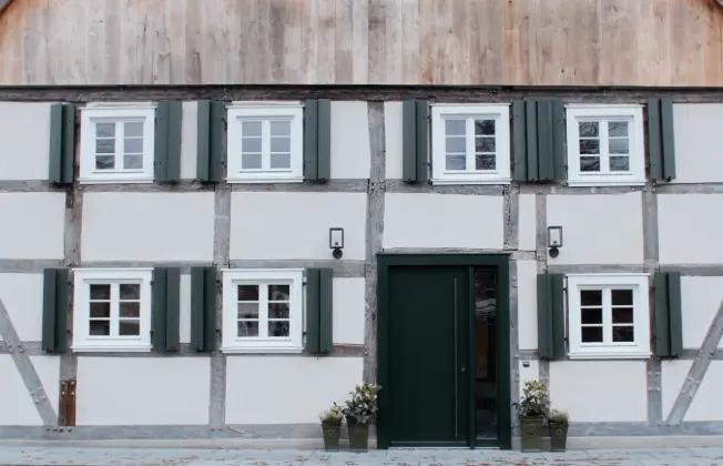 Front view of the timber-framed facade with original windows.