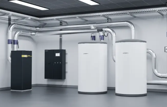 Geothermal heat pumps with peripherals, storage tank, and control cabinet in the boiler room.